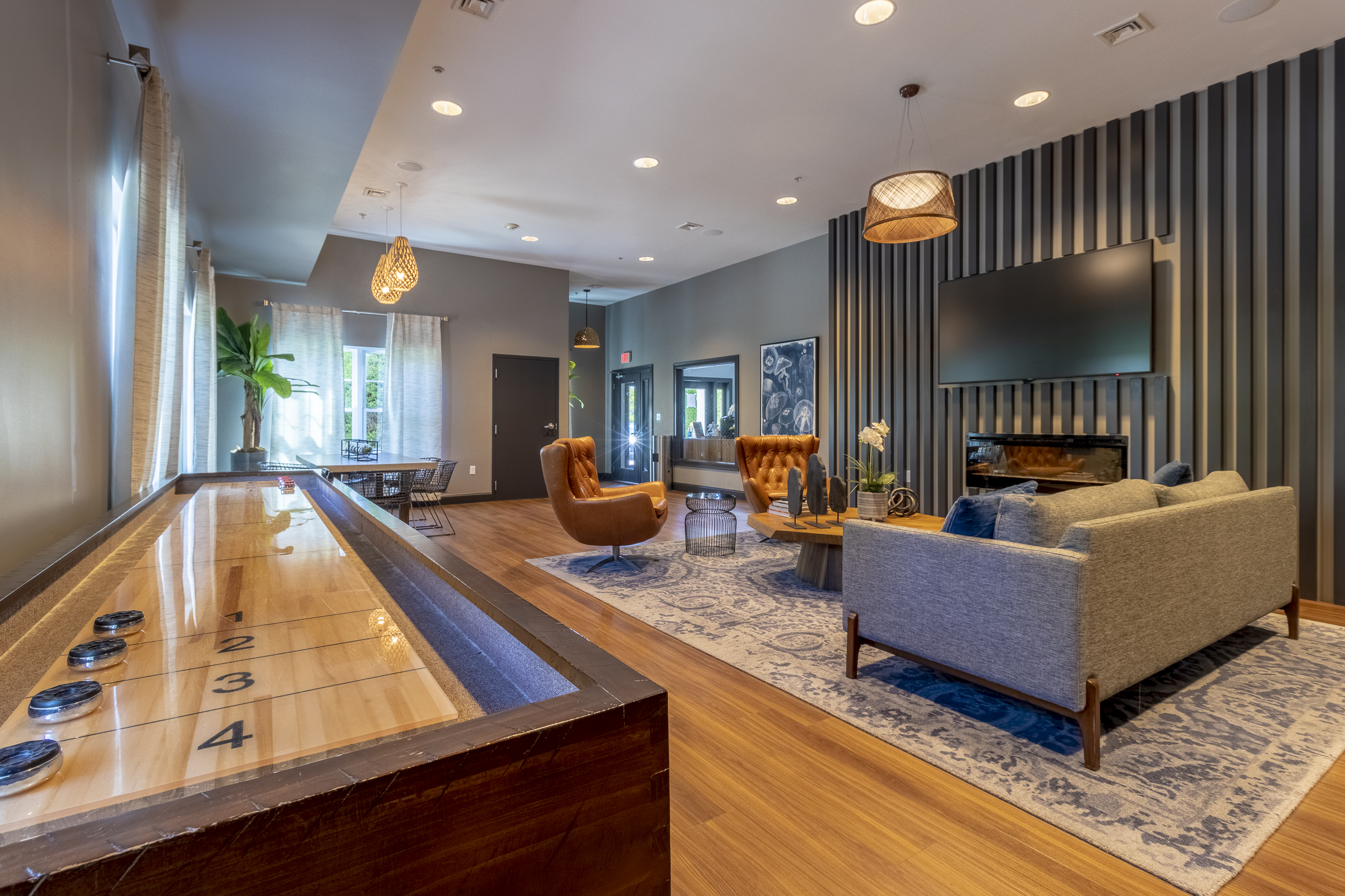 Community clubroom with seating and table game at The Point at Abington